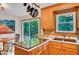 Kitchen featuring wood cabinets, stainless steel sink, with a view of the dining area and backyard at 2269 Sparrow Ridge Ne Dr, Marietta, GA 30066