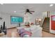 Bright living room with a ceiling fan, hardwood floors, and large windows overlooking trees at 2269 Sparrow Ridge Ne Dr, Marietta, GA 30066