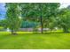 Lush backyard leading to a serene lake, framed by mature trees and a well-maintained lawn at 2538 Morgan Lake Ne Dr, Marietta, GA 30066