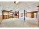 Large basement featuring carpet, paneled walls, built-in shelving, and bar area at 2538 Morgan Lake Ne Dr, Marietta, GA 30066