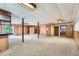 Spacious basement area with paneled walls, carpet flooring, and bar with sliding glass door to the exterior at 2538 Morgan Lake Ne Dr, Marietta, GA 30066