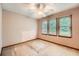 Bedroom featuring three windows providing natural light and neutral color scheme at 2538 Morgan Lake Ne Dr, Marietta, GA 30066