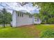 Backyard view of home, showcasing the deck, lawn, and mature trees at 2538 Morgan Lake Ne Dr, Marietta, GA 30066
