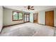 Main bedroom with carpet, ceiling fan, double doors to deck, and en suite bathroom at 2538 Morgan Lake Ne Dr, Marietta, GA 30066