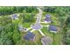 This aerial view showcases multiple homes within a neighborhood, manicured lawns, and mature trees at 4056 Friendship Creek Dr, Buford, GA 30519