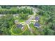 An aerial view of this home nestled within a scenic neighborhood surrounded by lush trees and landscaped yards at 4056 Friendship Creek Dr, Buford, GA 30519