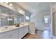Modern bathroom with double sinks, quartz counters, a glass-enclosed shower, and wood-look floors at 4056 Friendship Creek Dr, Buford, GA 30519