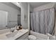 Clean bathroom with a modern vanity, a mirror, and a shower-tub combination with a stylish curtain at 4056 Friendship Creek Dr, Buford, GA 30519