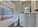 Bathroom with a tub and a shower with a periodic table shower curtain at 4056 Friendship Creek Dr, Buford, GA 30519