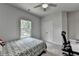 Cozy bedroom with neutral carpet, a ceiling fan, and a window overlooking the backyard at 4056 Friendship Creek Dr, Buford, GA 30519