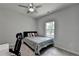 This bedroom features neutral walls, a ceiling fan, and a window providing natural light at 4056 Friendship Creek Dr, Buford, GA 30519