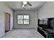 Neutral bedroom with a fan, closet, large window and carpet at 4056 Friendship Creek Dr, Buford, GA 30519