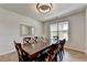 Bright dining room features an elegant chandelier, a large window, and a wooden table at 4056 Friendship Creek Dr, Buford, GA 30519