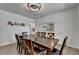 Bright dining room featuring wood-look flooring, a table with seating for eight, and neutral paint at 4056 Friendship Creek Dr, Buford, GA 30519