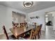 Bright dining room featuring wood-look flooring, a table with seating for eight, and neutral paint at 4056 Friendship Creek Dr, Buford, GA 30519
