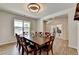Bright dining room featuring wood-look flooring, a table with seating for eight, and neutral paint at 4056 Friendship Creek Dr, Buford, GA 30519
