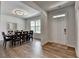Bright dining room featuring wood-look flooring, a table with seating for eight, and neutral paint at 4056 Friendship Creek Dr, Buford, GA 30519