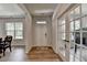 Bright entryway featuring wood-look flooring, a view of the dining area, and a nearby office with glass doors at 4056 Friendship Creek Dr, Buford, GA 30519
