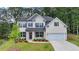 This home features a well-manicured lawn, charming shutters and an inviting porch, perfect for relaxing outside at 4056 Friendship Creek Dr, Buford, GA 30519