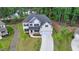 An aerial view of this two-story home with an attached two car garage, landscaped front yard, and light brick facade at 4056 Friendship Creek Dr, Buford, GA 30519