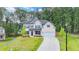 Charming two-story home with a well-manicured lawn and a welcoming front porch perfect for relaxing at 4056 Friendship Creek Dr, Buford, GA 30519