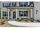 Inviting front porch with stylish seating, a welcoming wreath, and manicured landscaping for curb appeal at 4056 Friendship Creek Dr, Buford, GA 30519