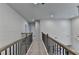 Upstairs hallway with neutral carpeting, dark railings, and multiple doors leading to bedrooms at 4056 Friendship Creek Dr, Buford, GA 30519