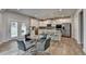 Open kitchen with stainless appliances, granite counters, an island, and a dining area at 4056 Friendship Creek Dr, Buford, GA 30519