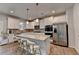Modern kitchen featuring a large center island, stainless steel appliances, and white cabinets at 4056 Friendship Creek Dr, Buford, GA 30519