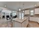 Spacious kitchen and living area featuring a large island, stainless steel appliances, and an open floor plan at 4056 Friendship Creek Dr, Buford, GA 30519