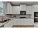 Modern kitchen with stainless steel appliances, white cabinets, granite countertops, and gray subway tile backsplash at 4056 Friendship Creek Dr, Buford, GA 30519
