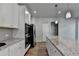 Open kitchen with white cabinets, stainless steel appliances, granite countertops, and an island at 4056 Friendship Creek Dr, Buford, GA 30519