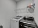 Laundry room features a new washer and dryer and shelving above at 4056 Friendship Creek Dr, Buford, GA 30519