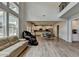 Bright and airy living room with large windows, views to the kitchen, and wood flooring at 4056 Friendship Creek Dr, Buford, GA 30519