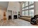 Living room featuring a fireplace, high ceilings, and large windows for natural light at 4056 Friendship Creek Dr, Buford, GA 30519