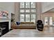 Spacious living room with fireplace, large windows, and a comfortable sofa at 4056 Friendship Creek Dr, Buford, GA 30519