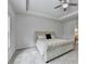 Inviting bedroom with a tray ceiling, comfortable bed, neutral tones, and a view to the ensuite bath at 4056 Friendship Creek Dr, Buford, GA 30519