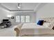 Serene main bedroom featuring a tray ceiling, workstation, and bright windows at 4056 Friendship Creek Dr, Buford, GA 30519