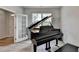 Music room with a grand piano, wood flooring, natural light, and french doors at 4056 Friendship Creek Dr, Buford, GA 30519