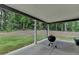 Covered patio with a barbecue grill, offering a perfect space for outdoor entertaining at 4056 Friendship Creek Dr, Buford, GA 30519