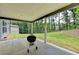 Covered patio with a barbecue grill, creating a perfect space for outdoor entertaining at 4056 Friendship Creek Dr, Buford, GA 30519