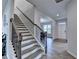 Elegant stairway with wooden handrails, black iron spindles, and views to the entry and dining spaces at 4056 Friendship Creek Dr, Buford, GA 30519