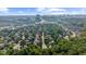 Expansive aerial view of a neighborhood with mature trees and a stunning cityscape in the distance at 745 Glengate Pl, Atlanta, GA 30328
