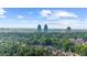 Scenic aerial shot of a lush neighborhood, showcasing mature trees and an impressive skyline backdrop at 745 Glengate Pl, Atlanta, GA 30328