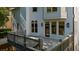 Backyard view of a two-story home featuring a deck, windows, and brick accent features at 745 Glengate Pl, Atlanta, GA 30328