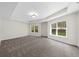 Tranquil bedroom with plush carpeting, tray ceilings, and large windows allowing ample natural light at 745 Glengate Pl, Atlanta, GA 30328