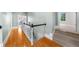Hallway features hardwood floors, white trim and walls, and a staircase with a black and white railing at 745 Glengate Pl, Atlanta, GA 30328