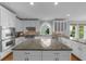 Well lit kitchen features granite countertops, stainless appliances, and a center island at 745 Glengate Pl, Atlanta, GA 30328