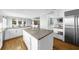 Bright kitchen features a large island, stainless appliances, and lots of cabinet storage and expansive countertops at 745 Glengate Pl, Atlanta, GA 30328