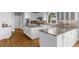 Modern kitchen with white cabinets, granite countertops, and stainless steel appliances at 745 Glengate Pl, Atlanta, GA 30328